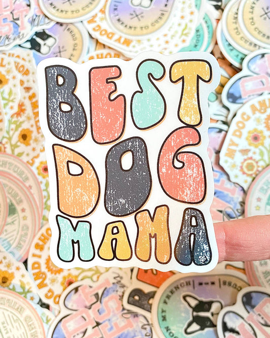 Best Dog Mama Retro Die Cut Sticker over a collection of colorful dog themed stickers